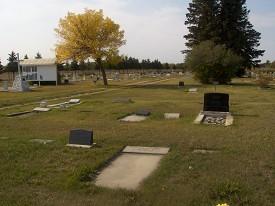 Berwyn Cemetery. There is a large plot of land with marked graves spread throughout.